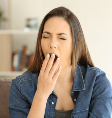 Woman feeling tired after acupuncture session — a common healing response as the nervous system resets
