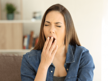 Woman feeling tired after acupuncture session — a common healing response as the nervous system resets